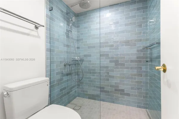 a bathroom with a toilet and shower