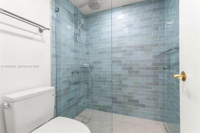 a bathroom with a toilet and shower