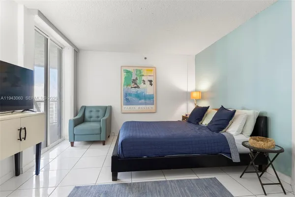 a bedroom with a bed and a flat screen tv
