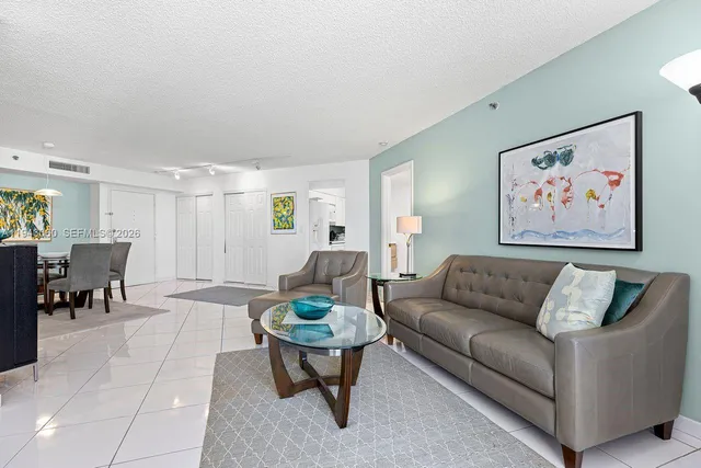 a living room with furniture and painting on the wall