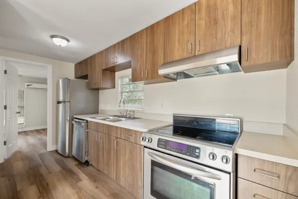 a kitchen with a stove and a refrigerator