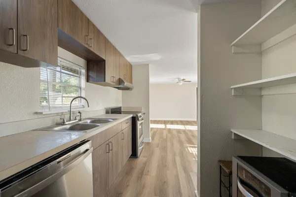 a kitchen with a sink stove and cabinets