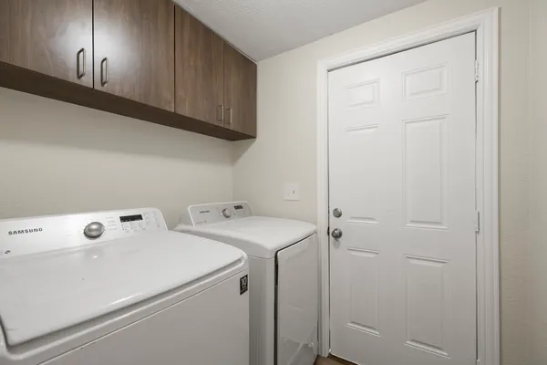 a view of storage and utility room with washer and dryer