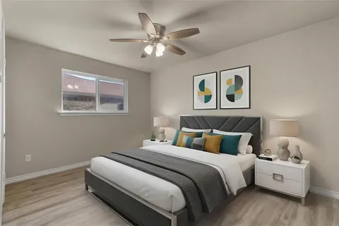 a bedroom with bed and paintings on the wall