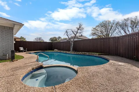 a view of a backyard with swimming pool