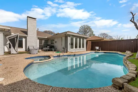 a view of a house with backyard porch and sitting area