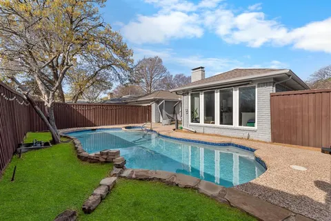 a view of a house with backyard and sitting area