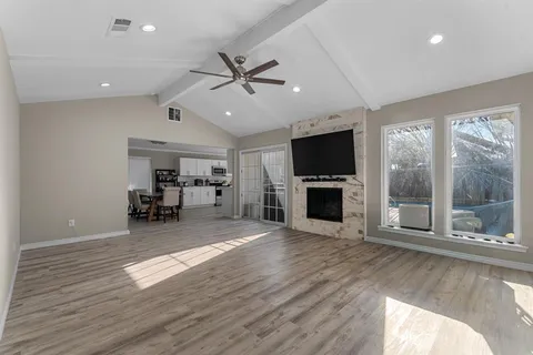 a view of a livingroom with furniture fireplace and a window