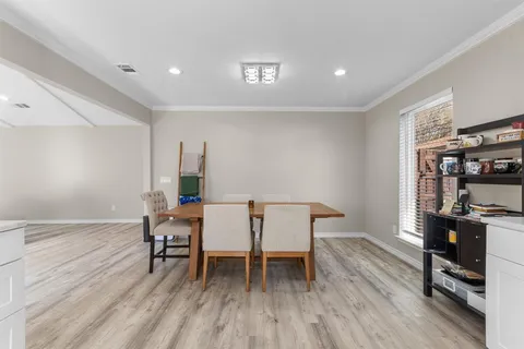 a dining room with furniture and wooden floor