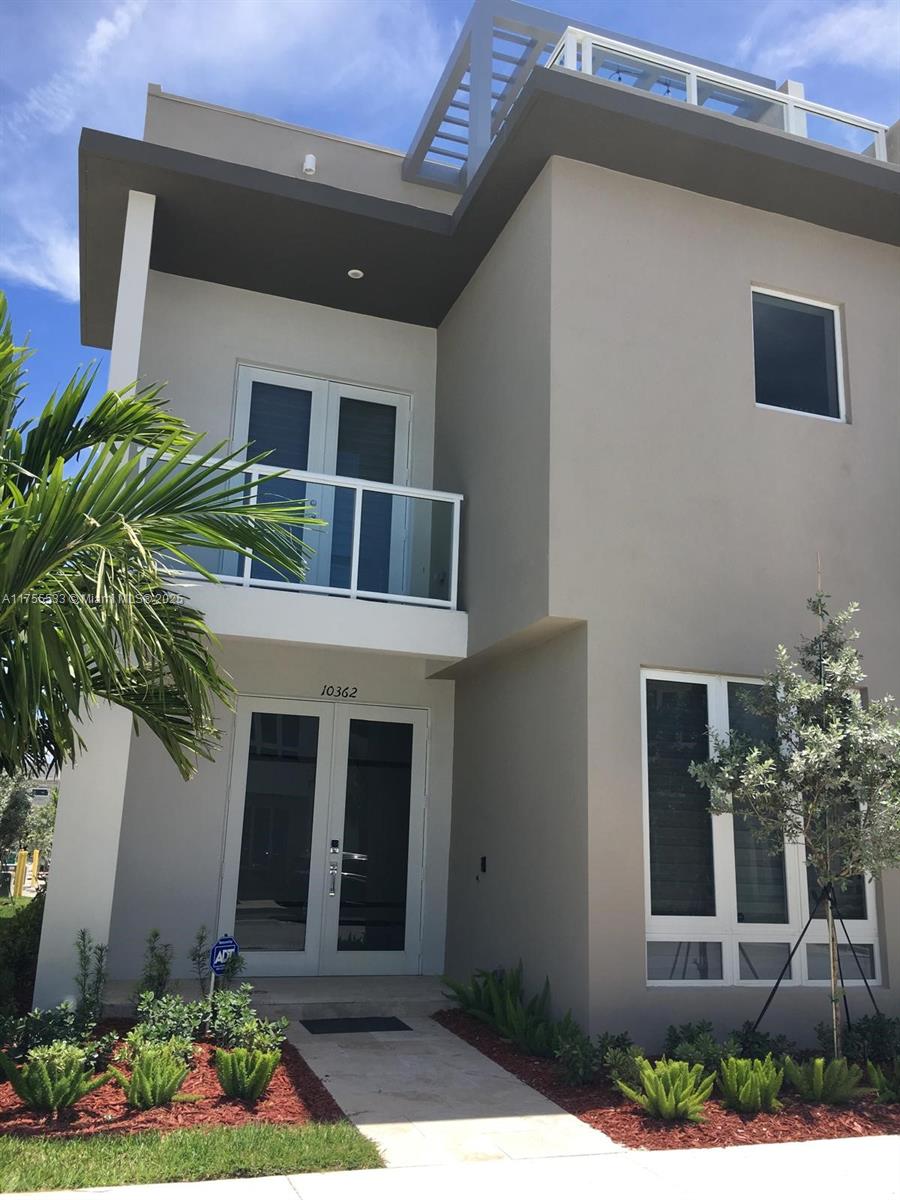 10362 Northwest 64th Terrace, Unit 10362 Doral, FL 33178 - Photo 1 of 29 a front view of a house with plants