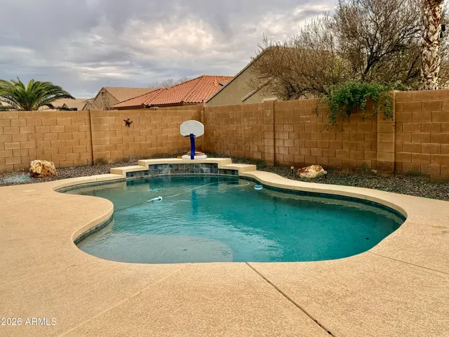 a view of a swimming pool with a yard