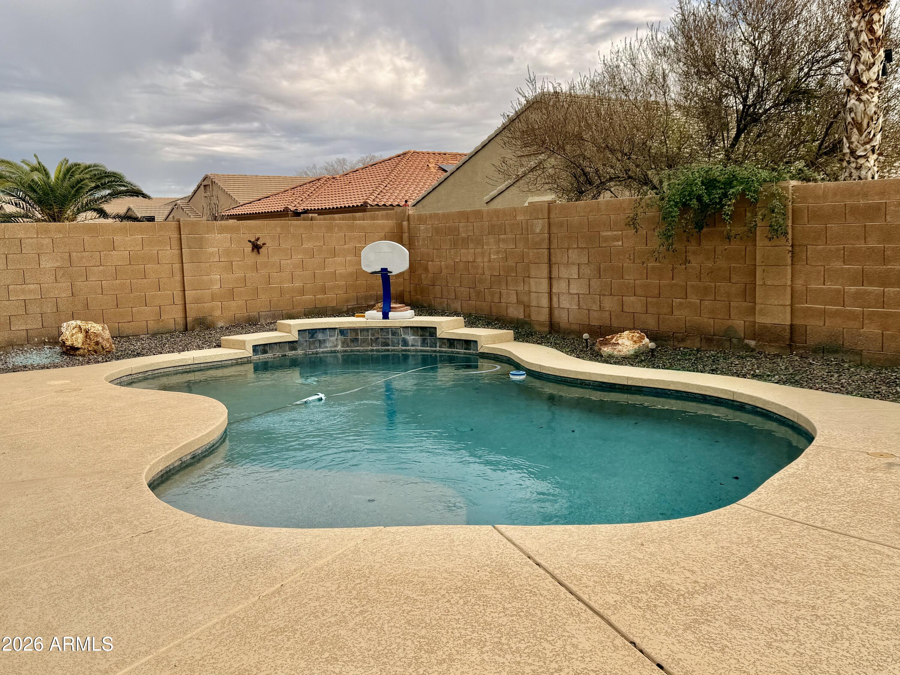 42645 West Venture Road Maricopa, AZ 85138 - Photo 14 of 37 a view of a swimming pool with a yard