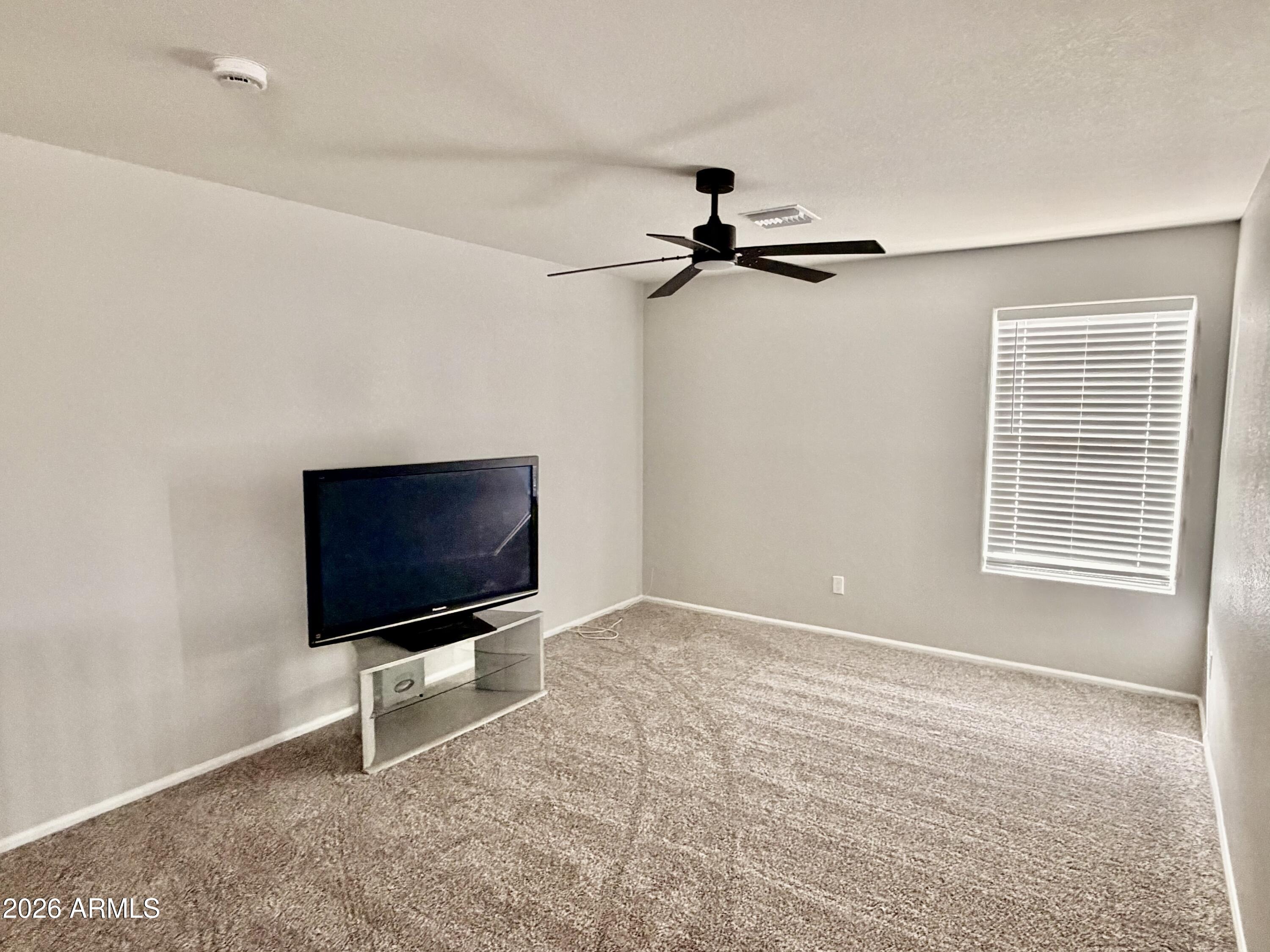 42645 West Venture Road Maricopa, AZ 85138 - Photo 19 of 37 a living room with a flat screen tv and a window