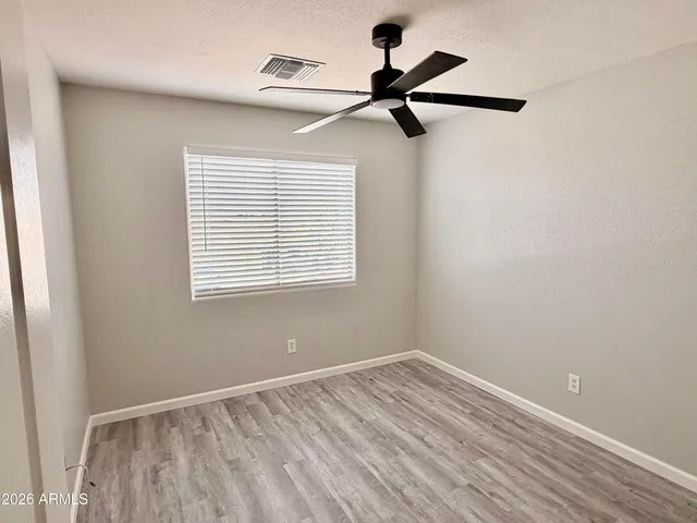a view of a room with a window and a ceiling fan