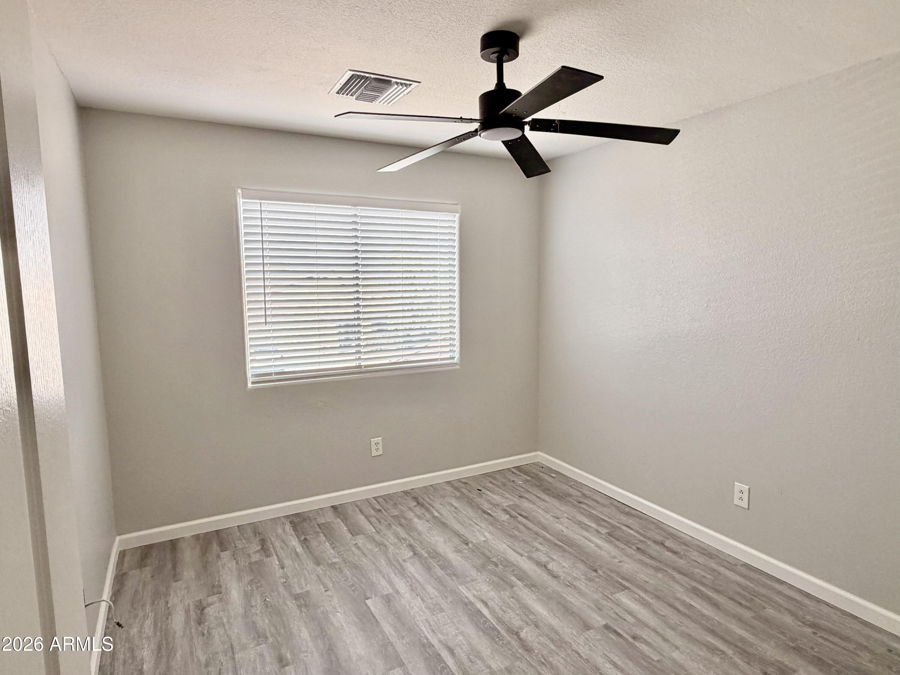 42645 West Venture Road Maricopa, AZ 85138 - Photo 24 of 37 a view of a room with a window and a ceiling fan
