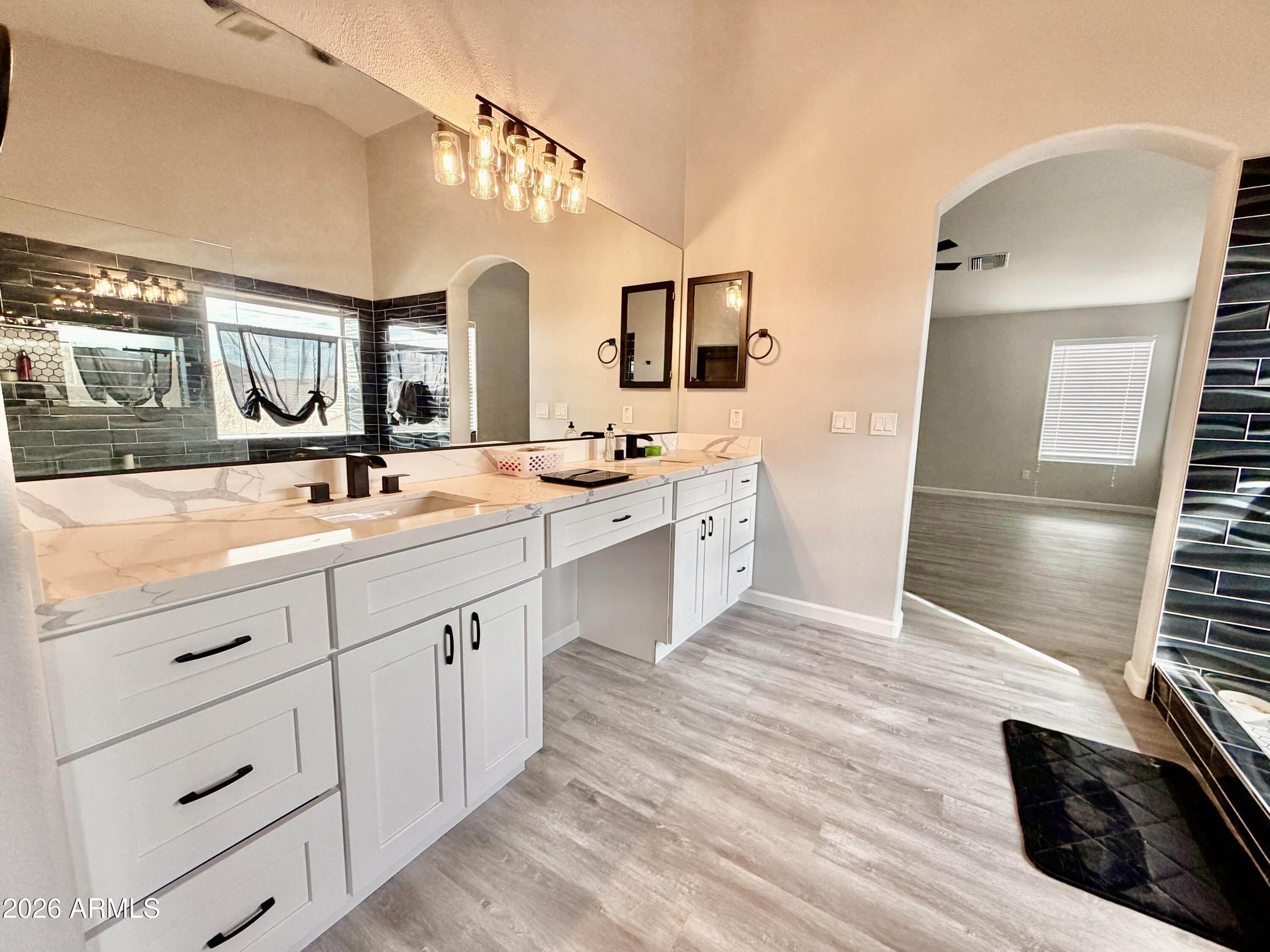 42645 West Venture Road Maricopa, AZ 85138 - Photo 25 of 37 a spacious bathroom with a double vanity sink a mirror and a shower