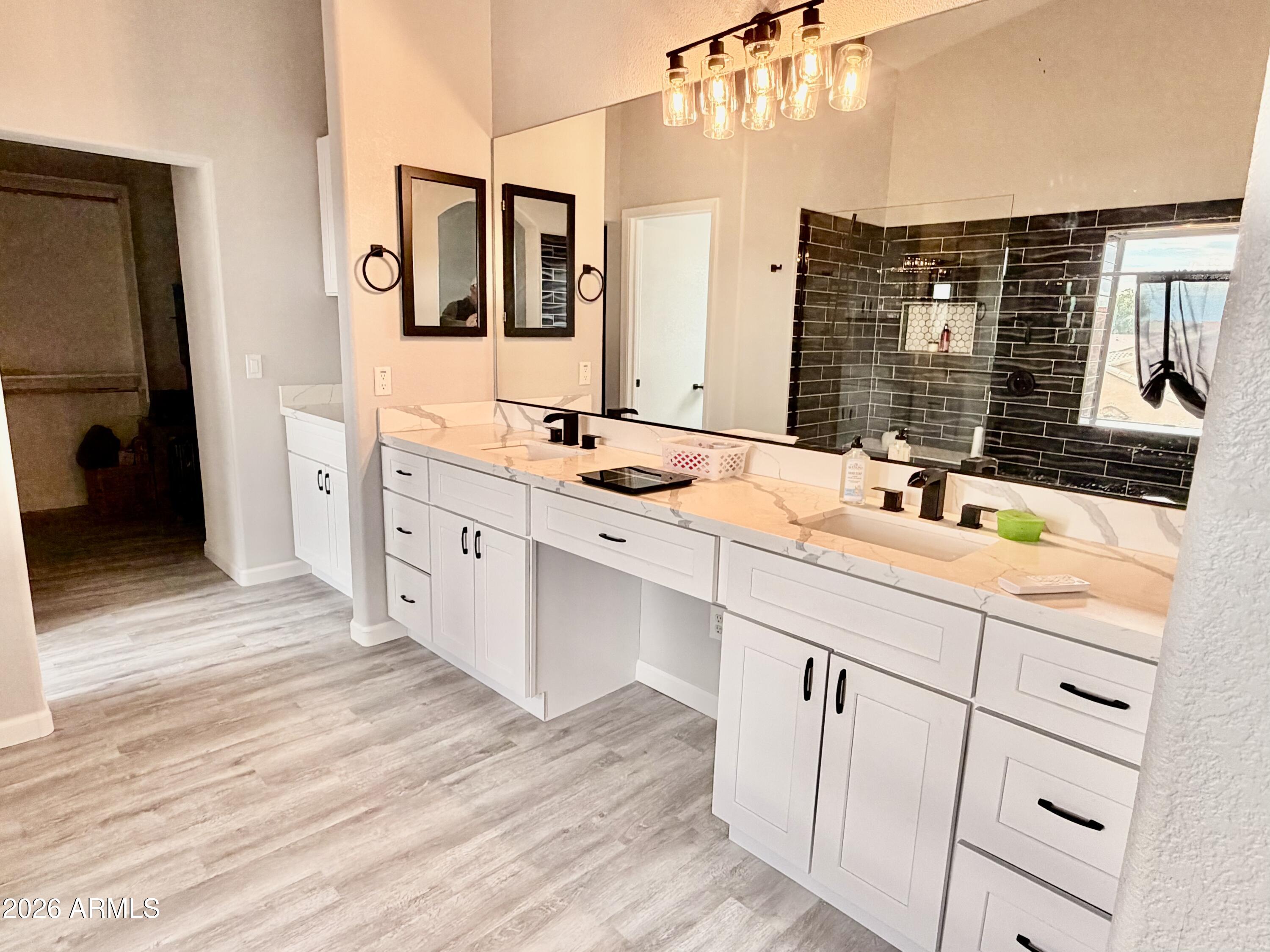 42645 West Venture Road Maricopa, AZ 85138 - Photo 28 of 37 a bathroom with a sink and a mirror