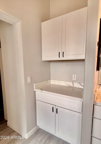 a kitchen with white cabinets and a sink