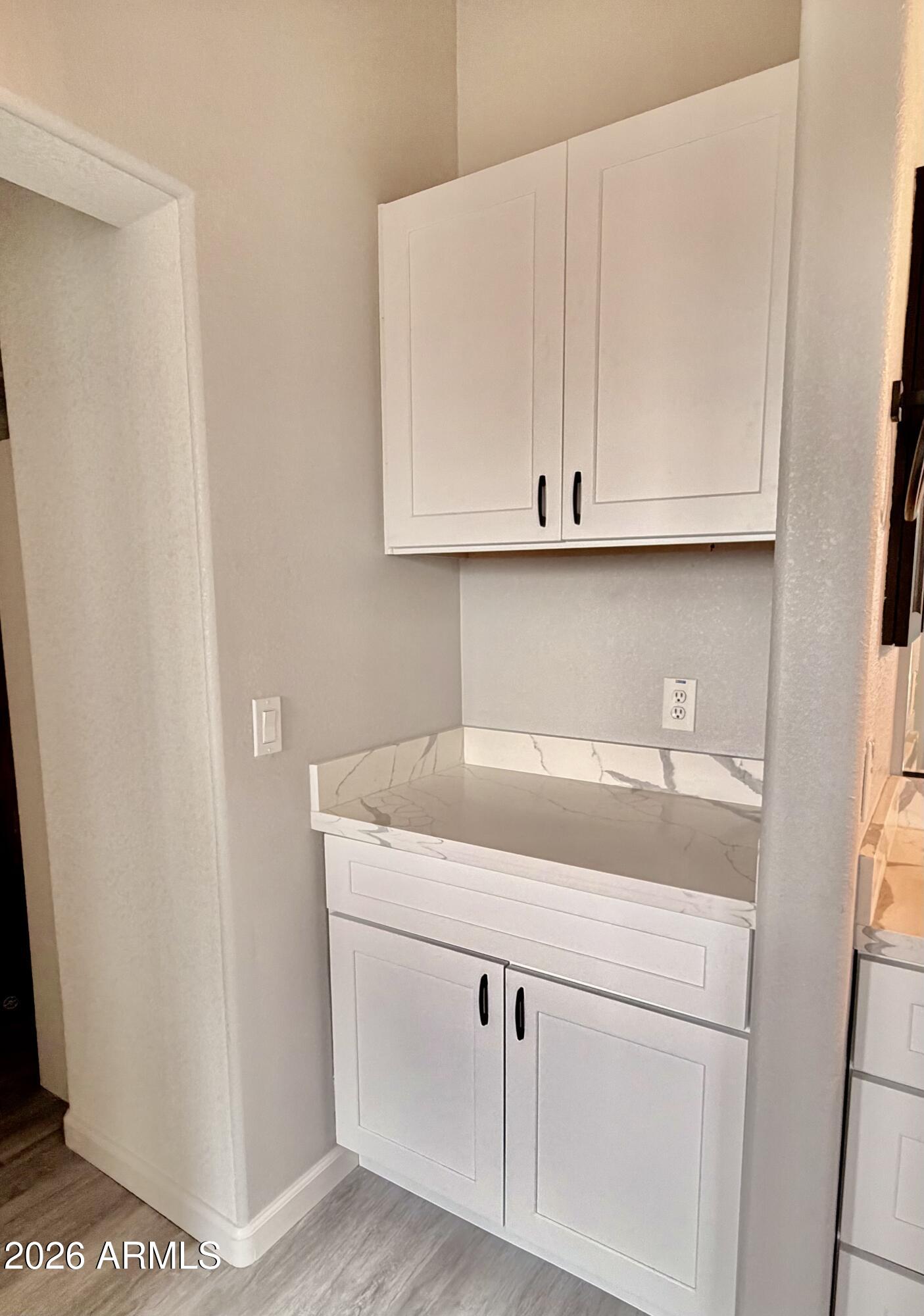 42645 West Venture Road Maricopa, AZ 85138 - Photo 29 of 37 a kitchen with white cabinets and a sink