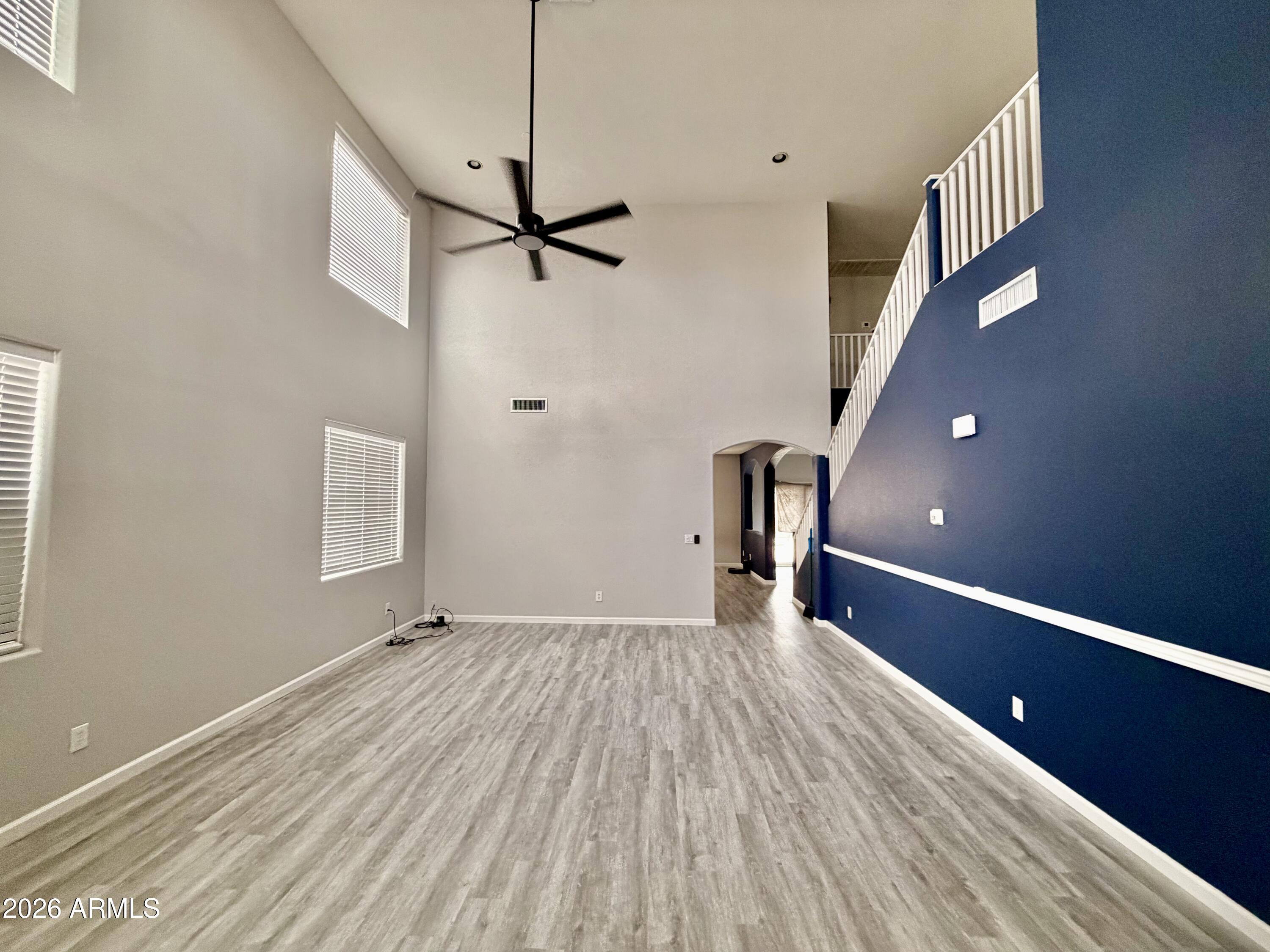 42645 West Venture Road Maricopa, AZ 85138 - Photo 3 of 37 a view of empty room with wooden floor