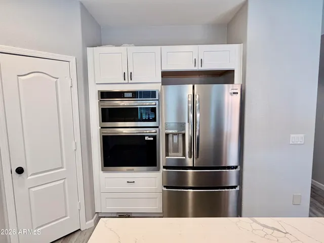 a kitchen with stainless steel appliances and refrigerator