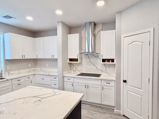 a kitchen with white cabinets and white appliances