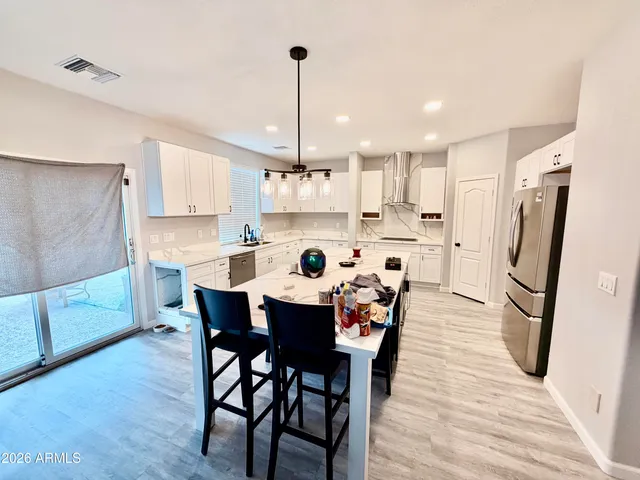 a large kitchen with a table and chairs