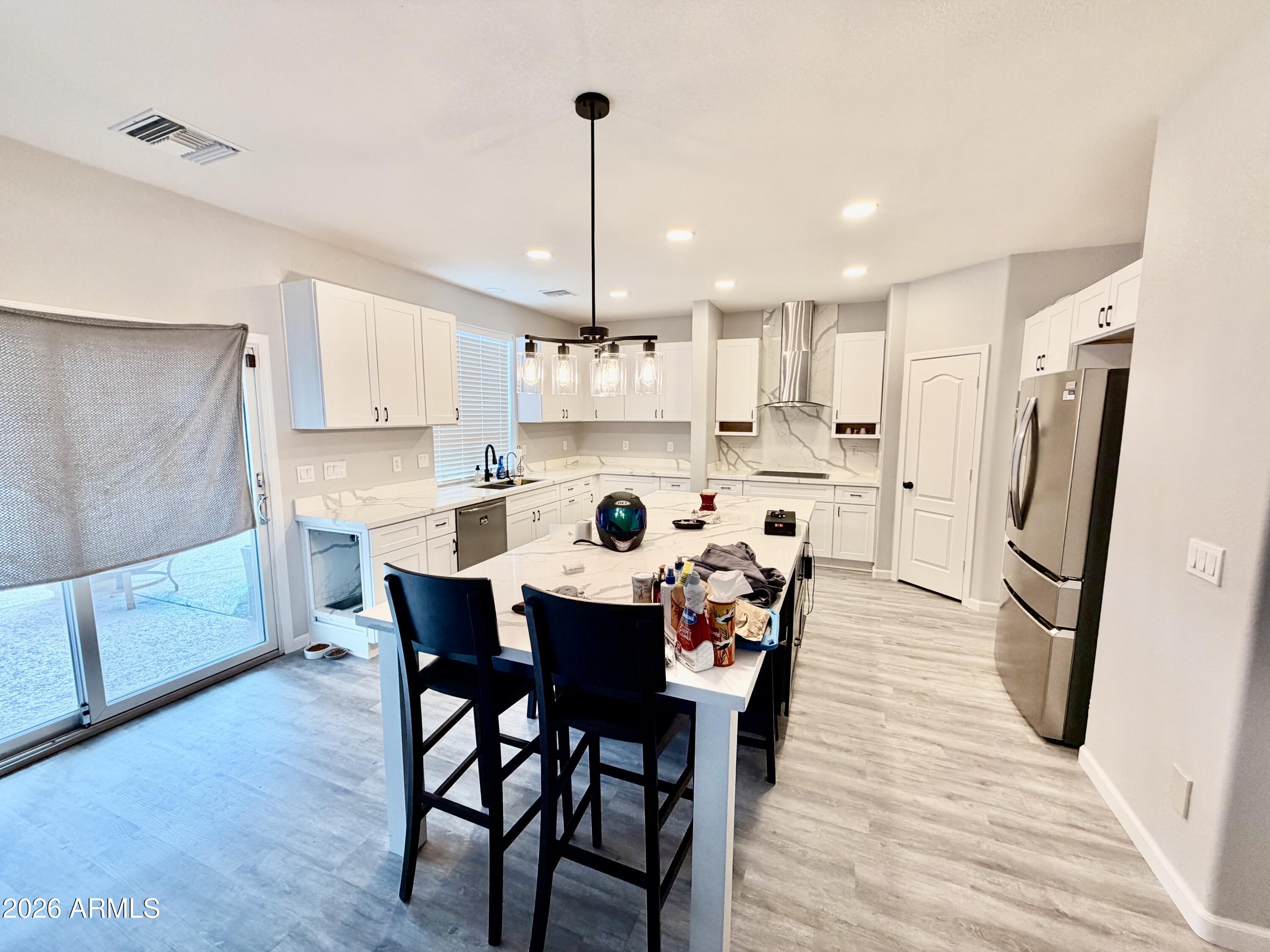 42645 West Venture Road Maricopa, AZ 85138 - Photo 10 of 37 a large kitchen with a table and chairs