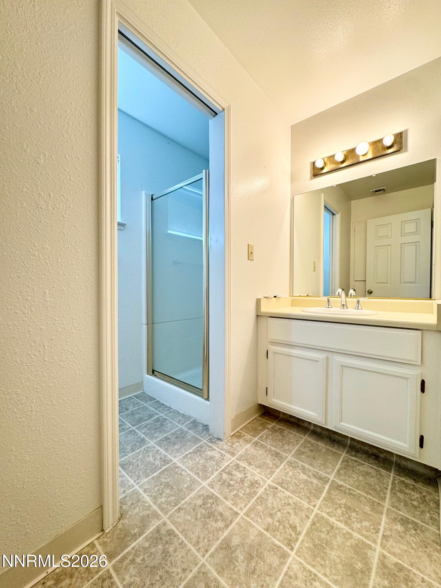 7541 Lighthouse Lane Reno, NV 89511 - Photo 13 of 24 a bathroom with a sink vanity and a mirror