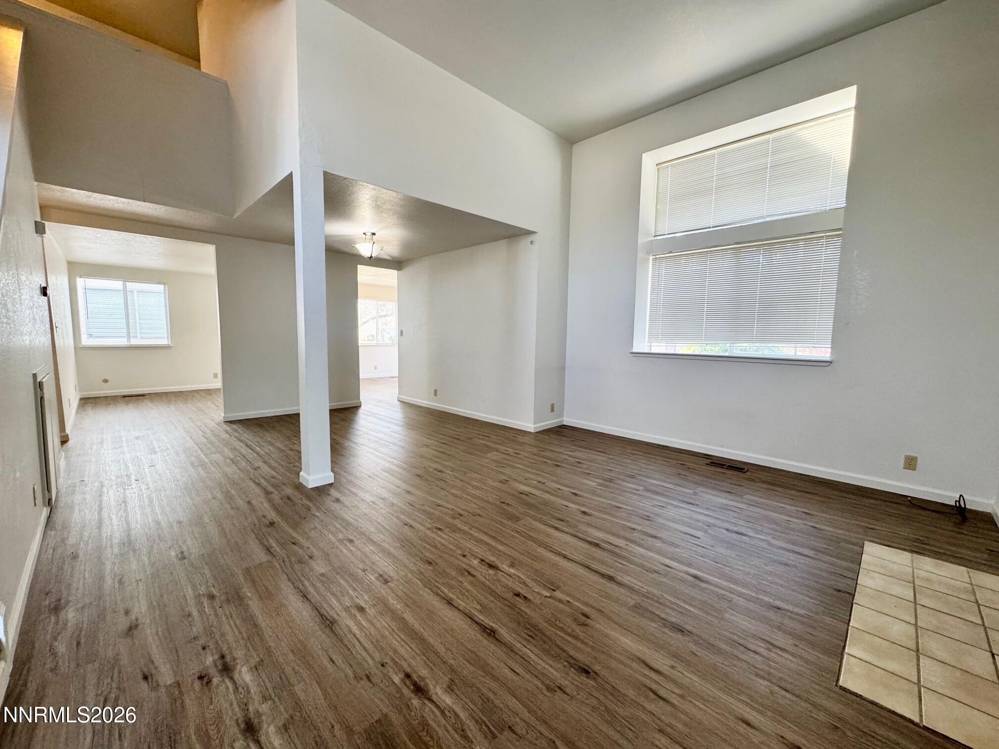 7541 Lighthouse Lane Reno, NV 89511 - Photo 4 of 24 an empty room with wooden floor and a window