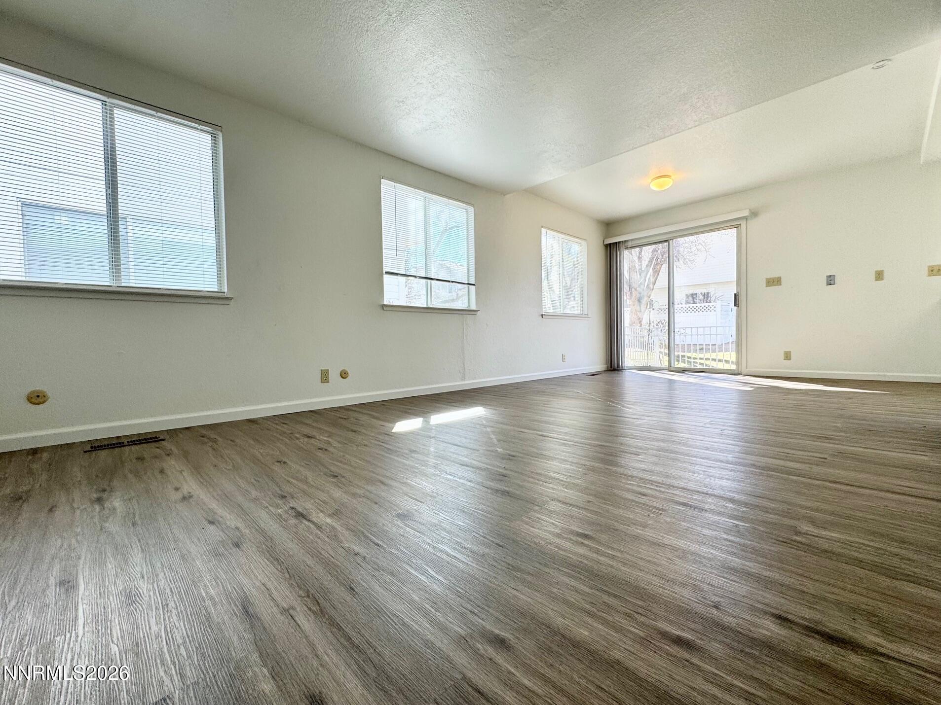 7541 Lighthouse Lane Reno, NV 89511 - Photo 5 of 24 an empty room with wooden floor and windows