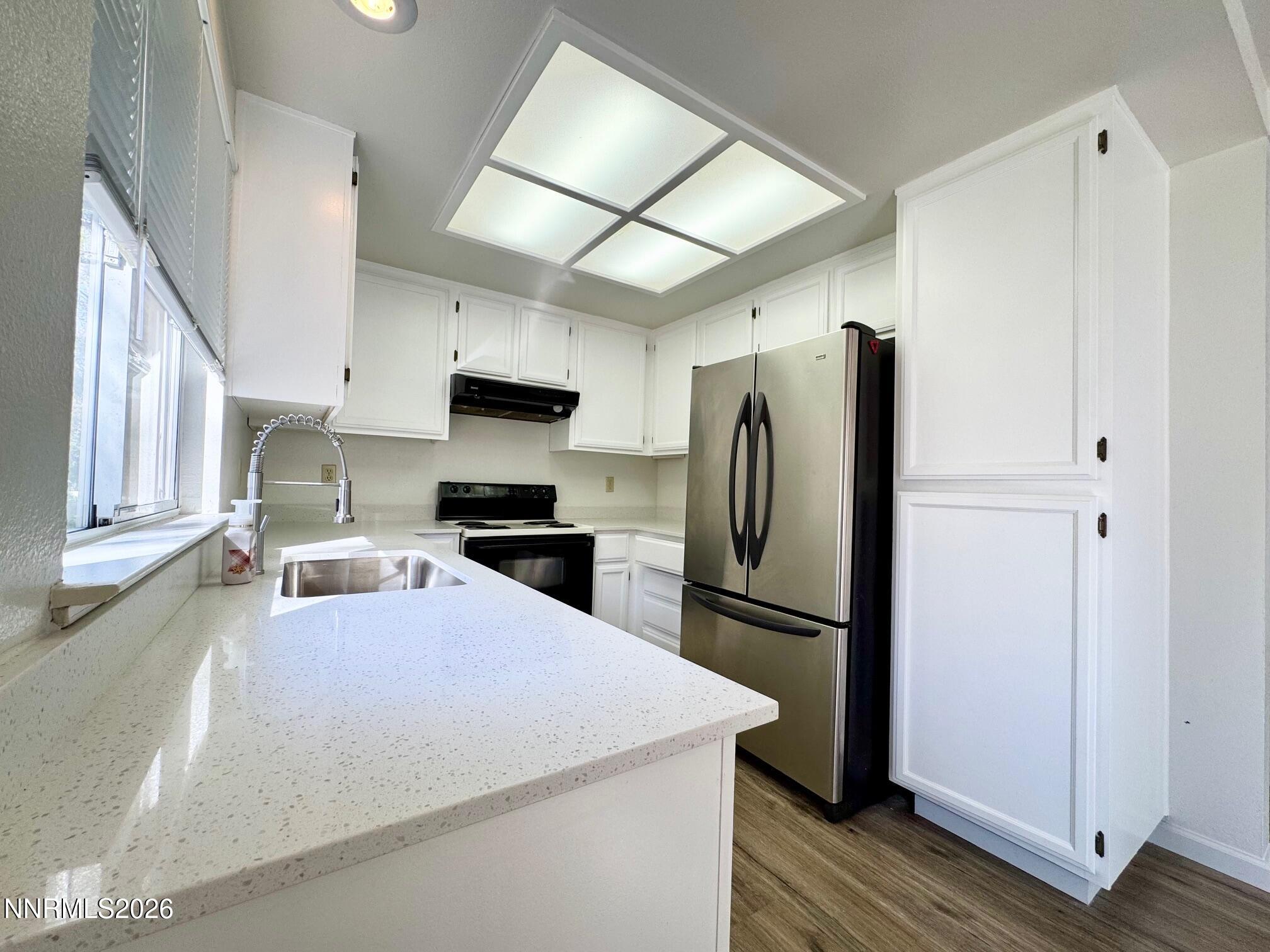 7541 Lighthouse Lane Reno, NV 89511 - Photo 6 of 24 a kitchen with stainless steel appliances granite countertop a refrigerator stove a sink and dishwasher