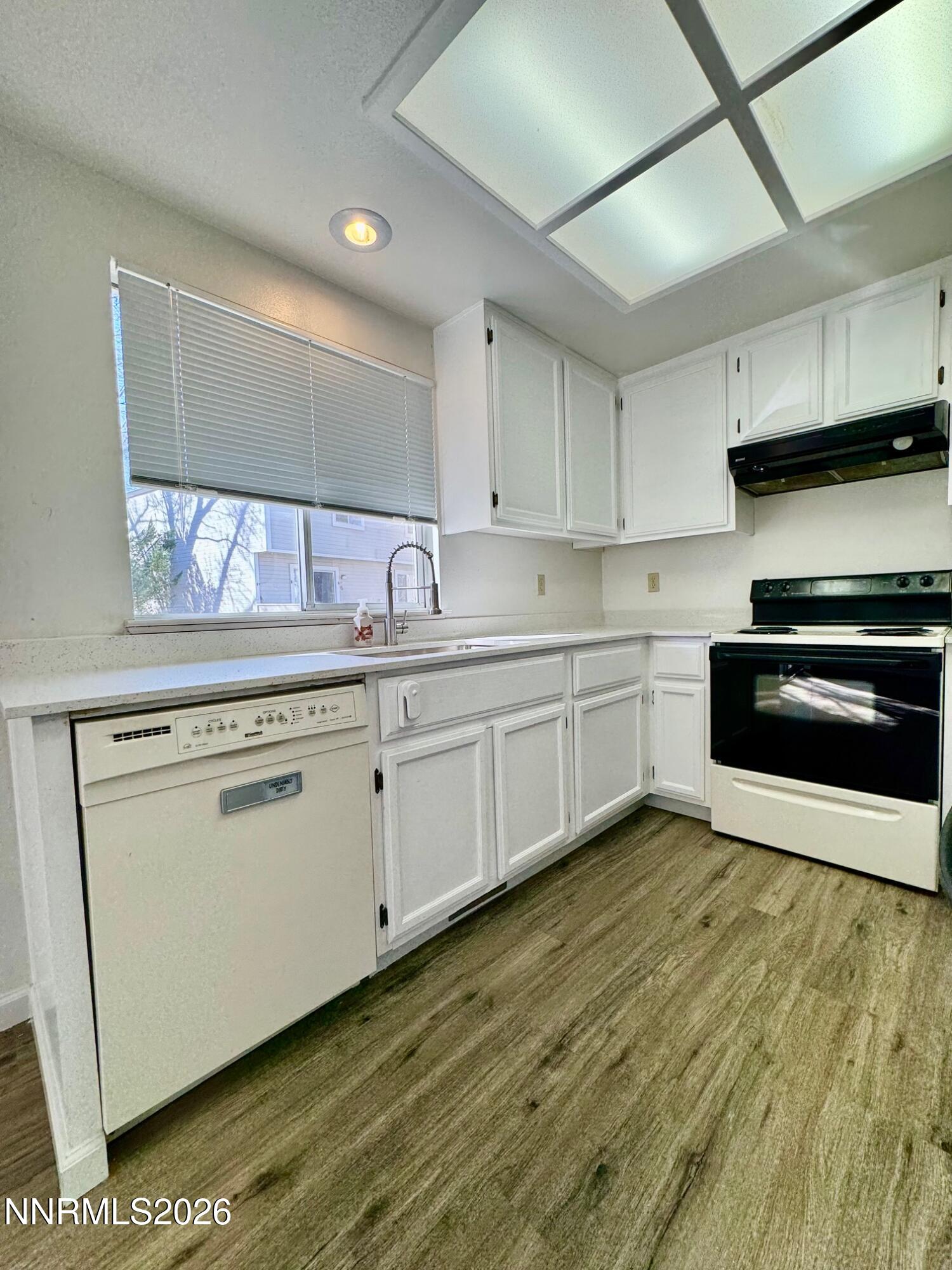 7541 Lighthouse Lane Reno, NV 89511 - Photo 8 of 24 a kitchen with stainless steel appliances a sink cabinets and wooden floor