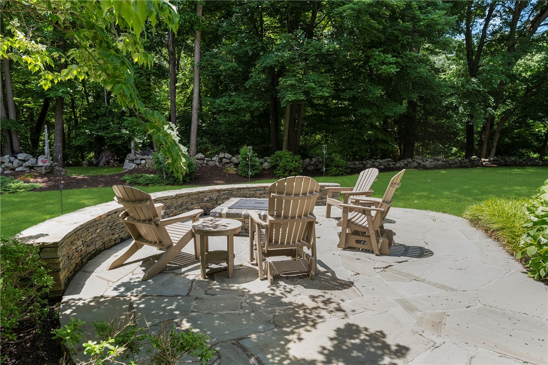 8 Howland Farm Road East Greenwich, RI 02818 - Photo 36 of 42 Lovely stone patio, sitting wall and built-in fire pit.