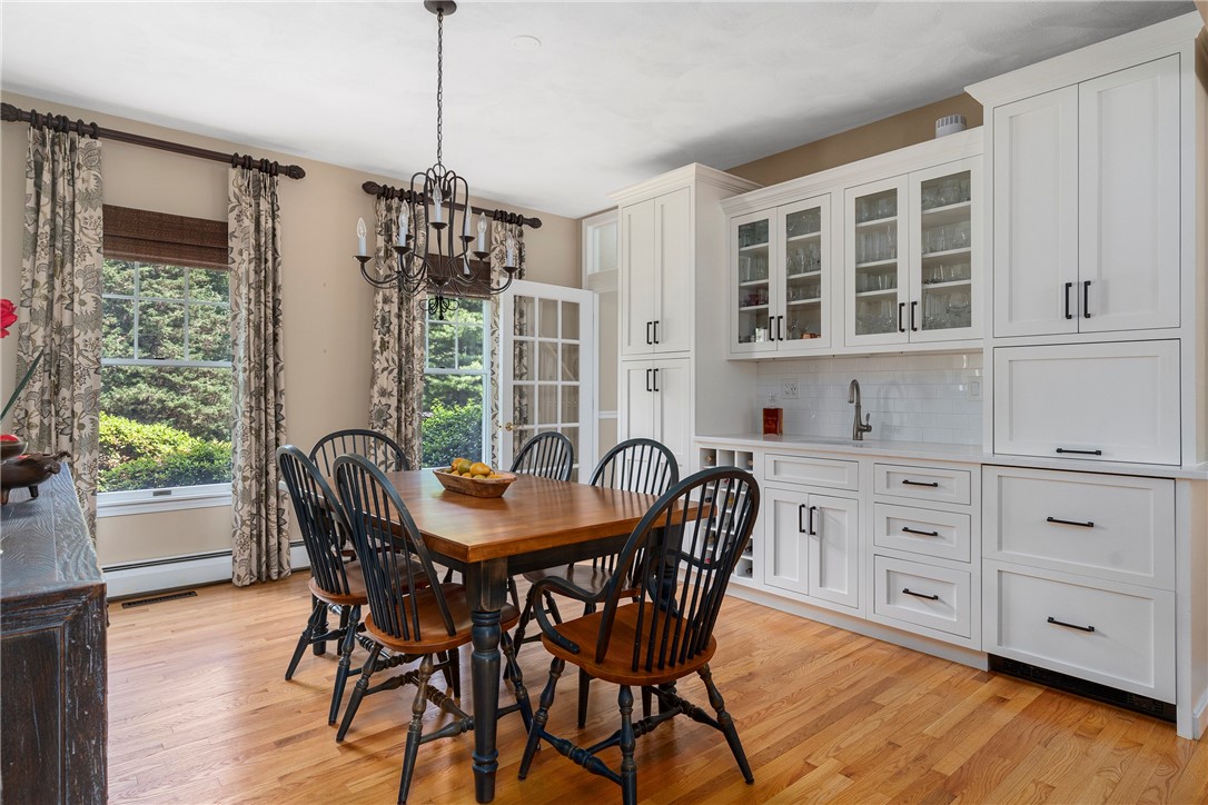 8 Howland Farm Road East Greenwich, RI 02818 - Photo 10 of 42 Dining room with glass front cabinetry, storage, wet bar, beverage refrigerator and freezer with ice maker