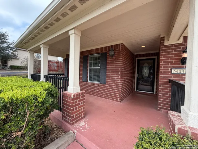 front view of a house with potted plants