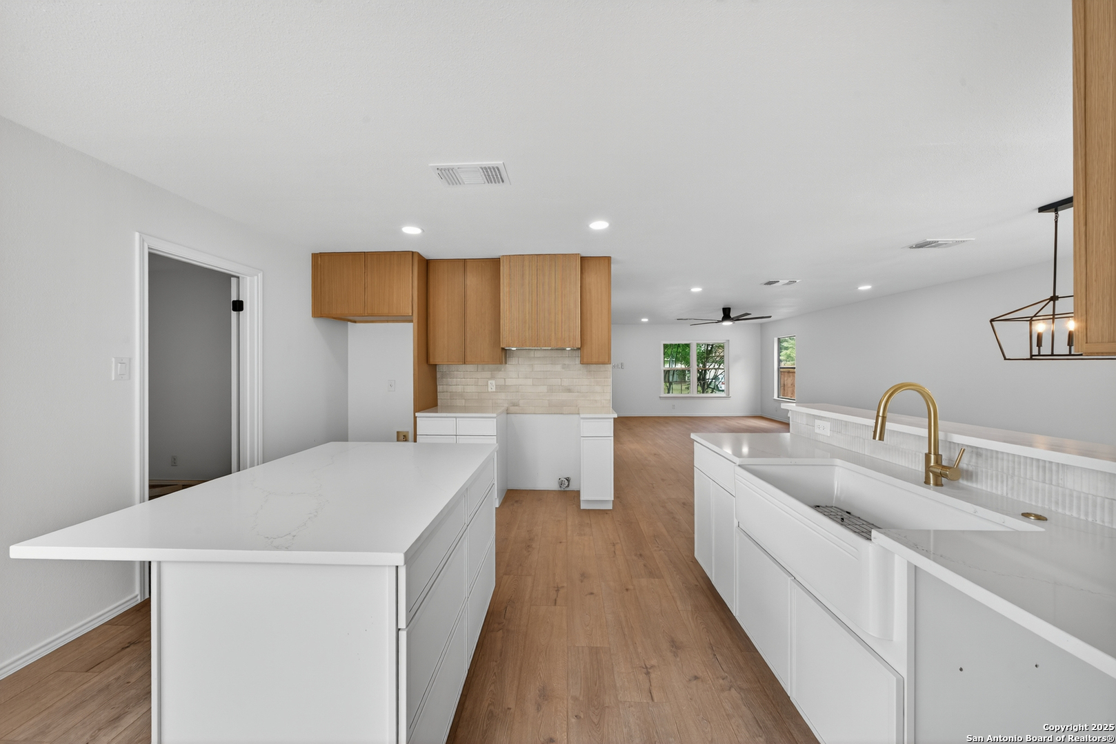 12110 Branding Point Helotes, TX 78023 - Photo 12 of 40 a kitchen with a sink a counter top space stainless steel appliances and cabinets