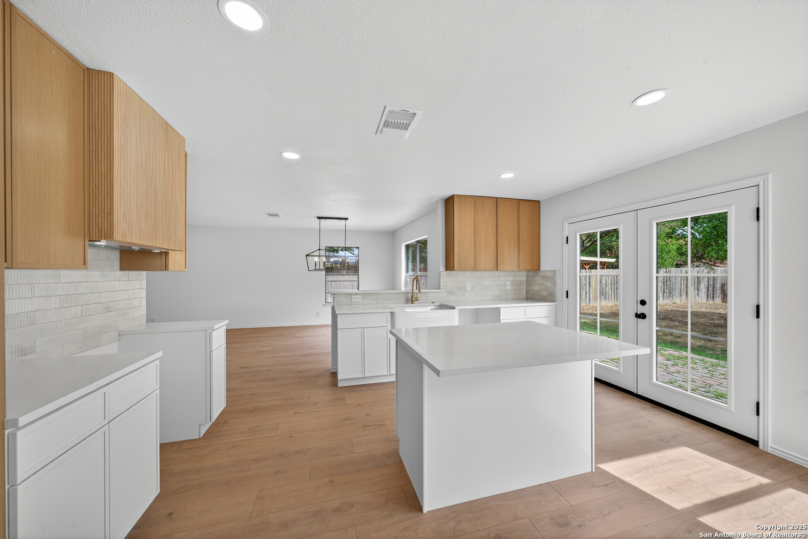 12110 Branding Point Helotes, TX 78023 - Photo 14 of 40 a large kitchen with kitchen island a sink a counter top space and cabinets