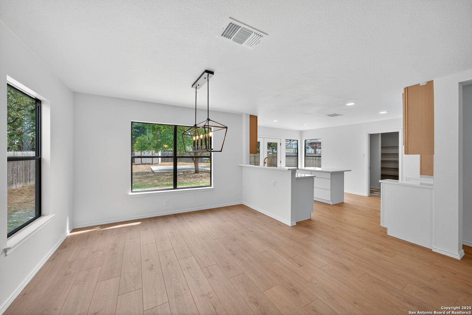 12110 Branding Point Helotes, TX 78023 - Photo 17 of 40 a view of a kitchen with furniture and wooden floor