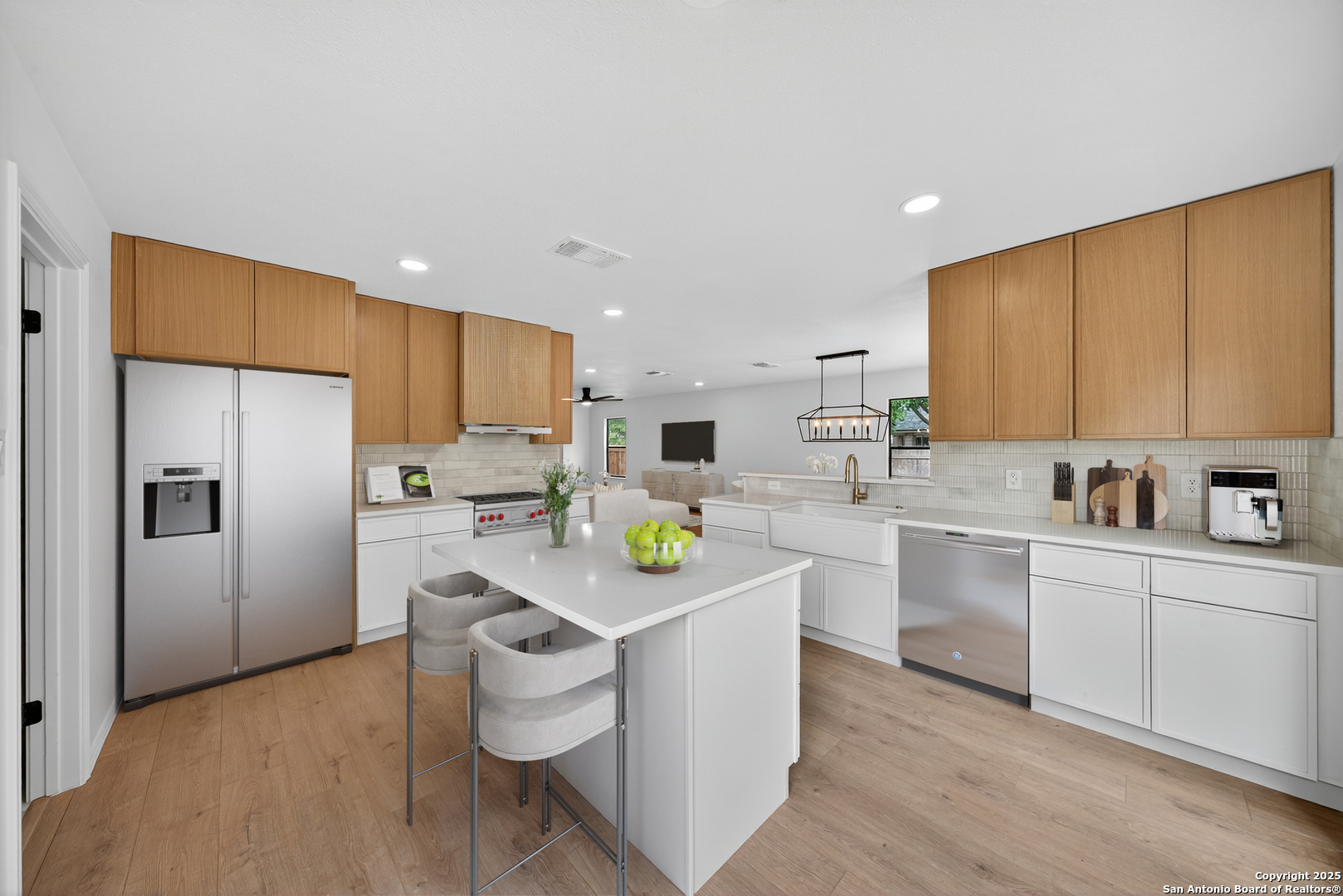 12110 Branding Point Helotes, TX 78023 - Photo 2 of 40 a kitchen with stainless steel appliances white cabinets and wooden floors