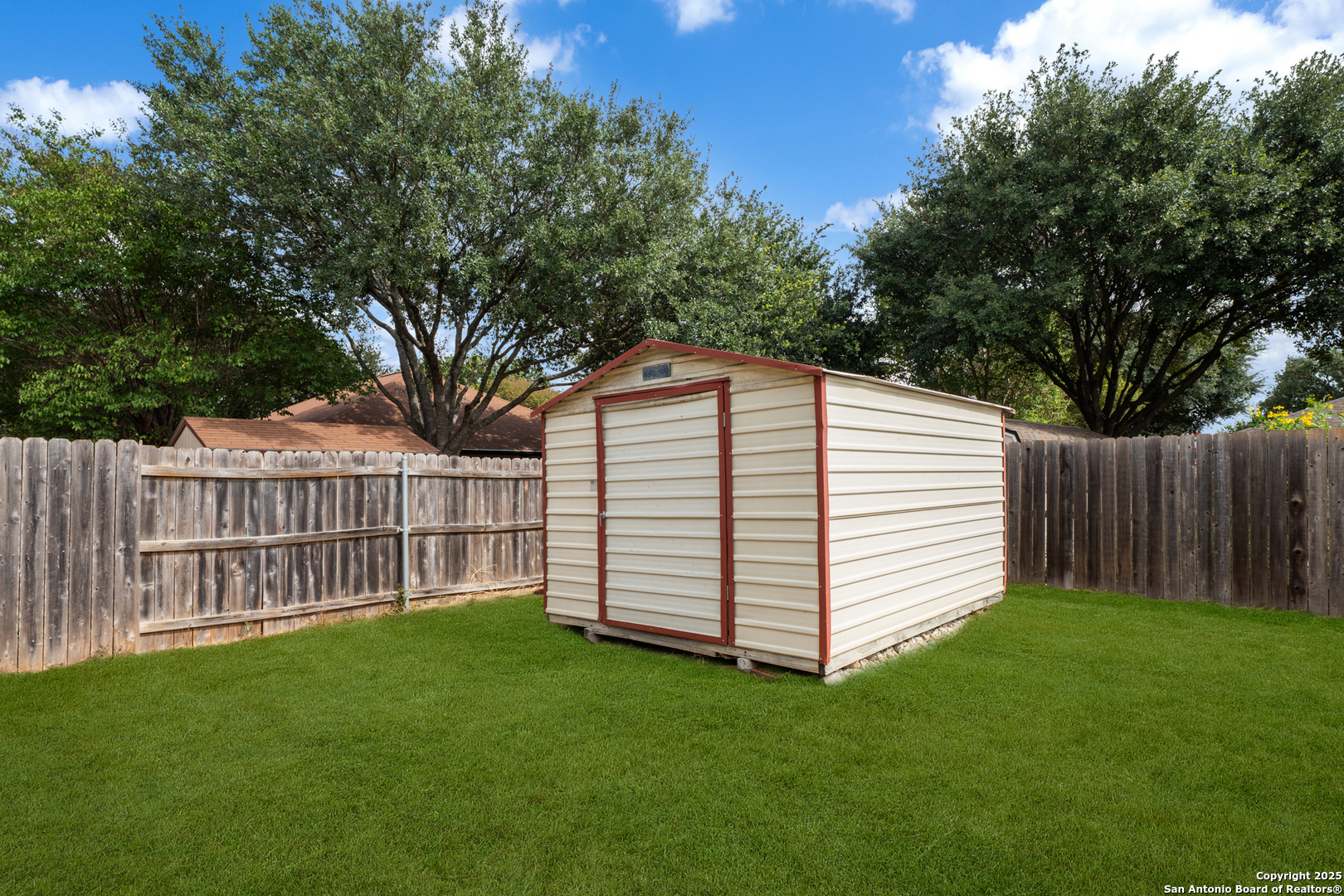 12110 Branding Point Helotes, TX 78023 - Photo 31 of 40 a view of a white house with a small yard and large trees