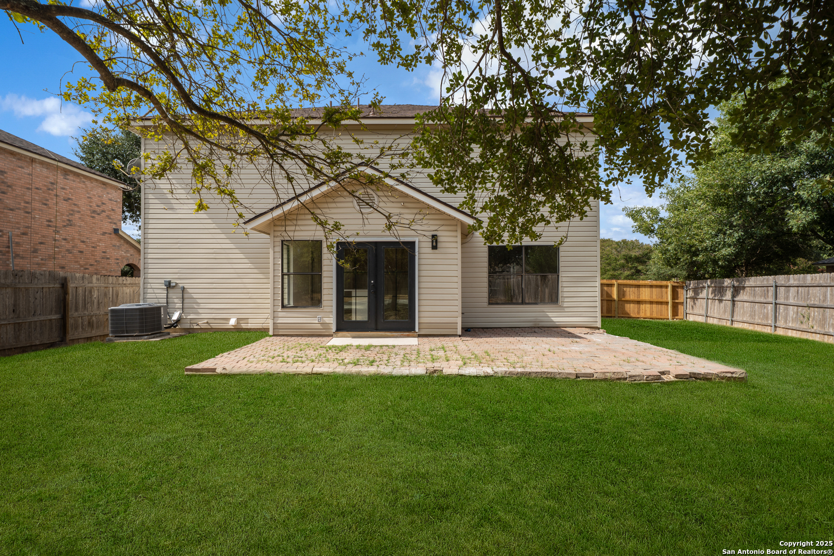 12110 Branding Point Helotes, TX 78023 - Photo 36 of 40 a front view of a house with a garden and yard