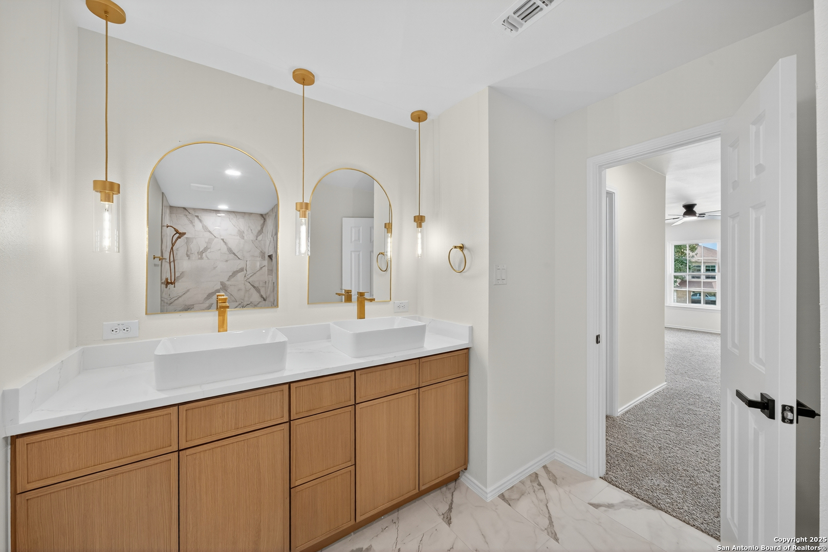 12110 Branding Point Helotes, TX 78023 - Photo 6 of 40 a bathroom with a double vanity sink and a mirror