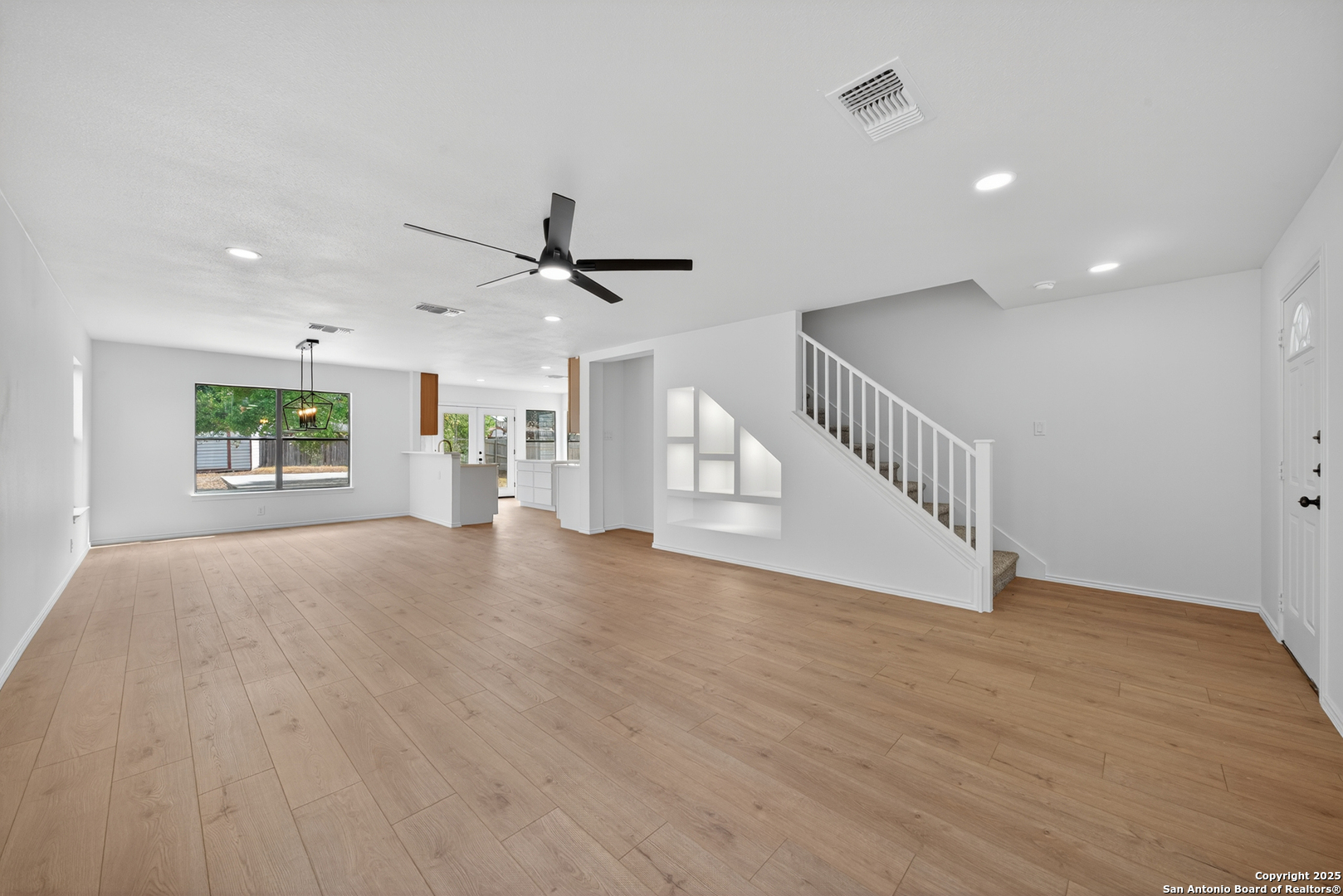 12110 Branding Point Helotes, TX 78023 - Photo 9 of 40 a view of an empty room with a window and wooden floor