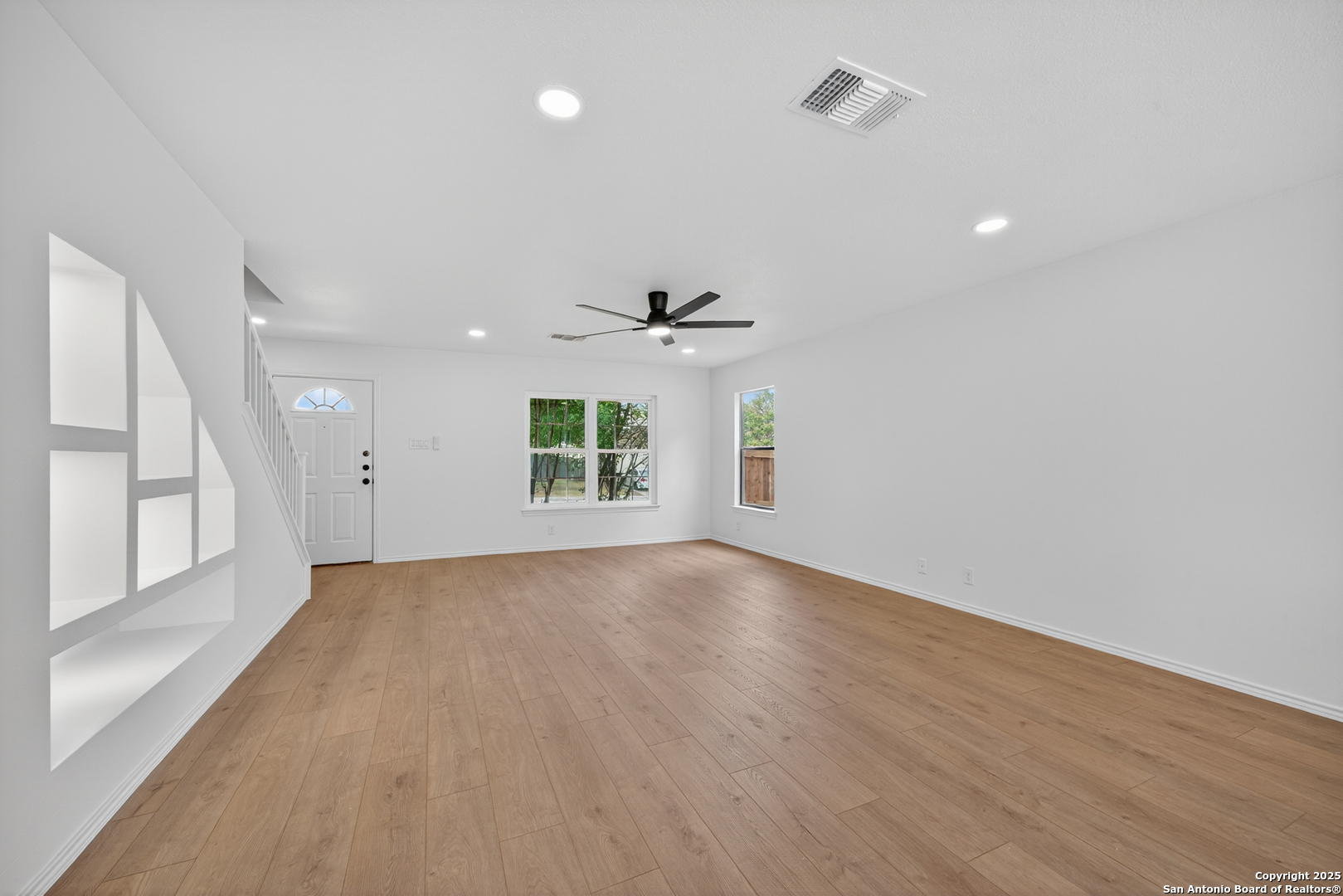 12110 Branding Point Helotes, TX 78023 - Photo 10 of 40 an empty room with wooden floor and windows