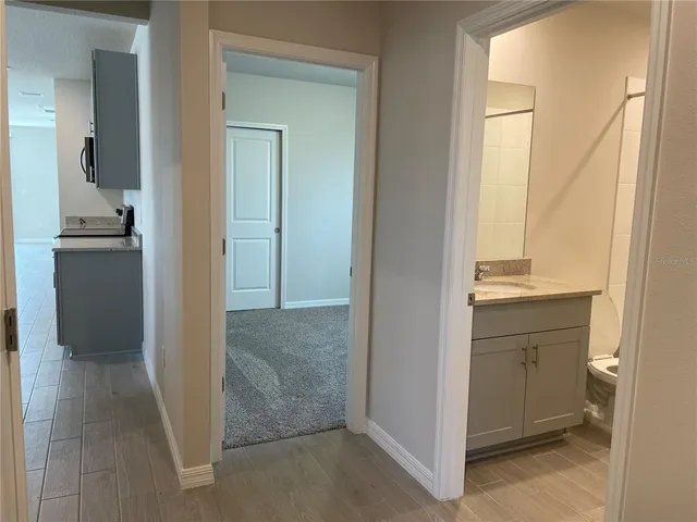 a view of a bathroom from a corridor