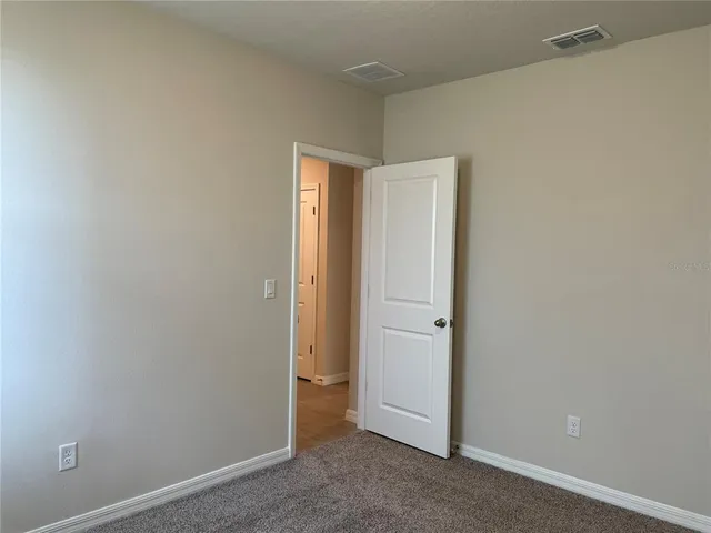an empty room with closet area