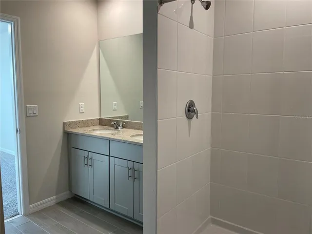 a bathroom with a shower and a sink