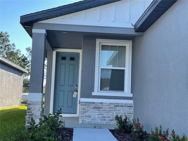 a front view of a house with a plants