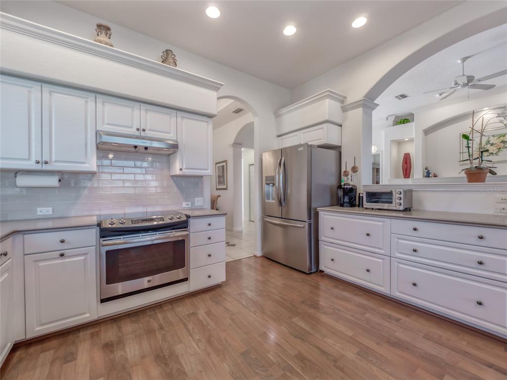 6631 Waters Edge Way Lakewood Ranch, FL 34202 - Photo 25 of 78 a kitchen with stainless steel appliances white cabinets and a refrigerator